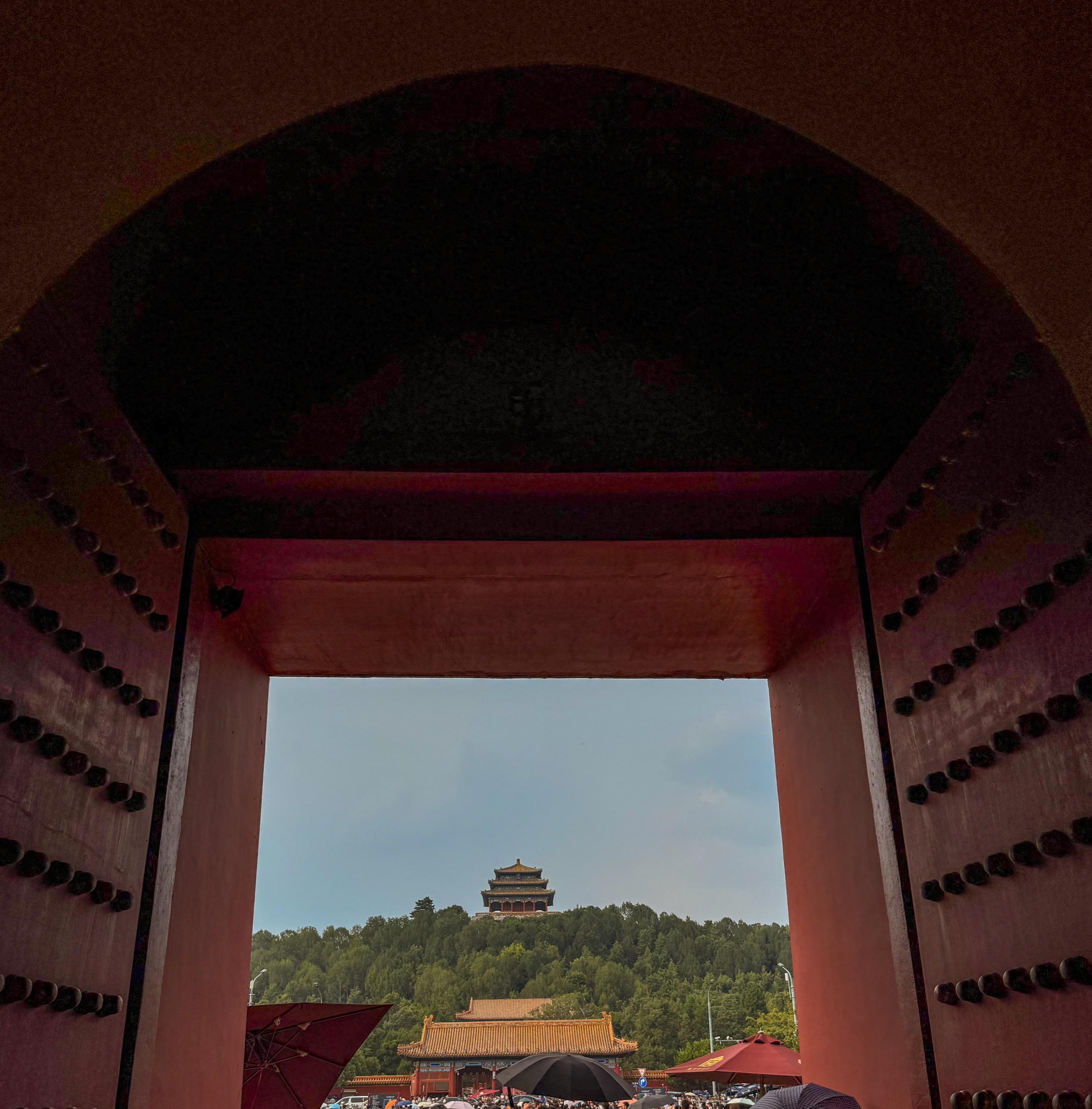 A temple seen through a red palace gate