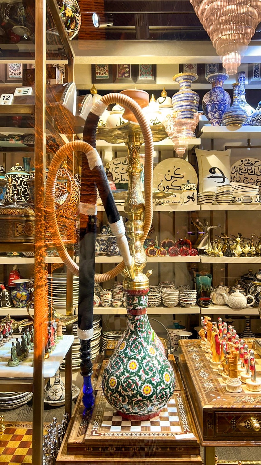 Decorative hookah surrounded by ceramics
