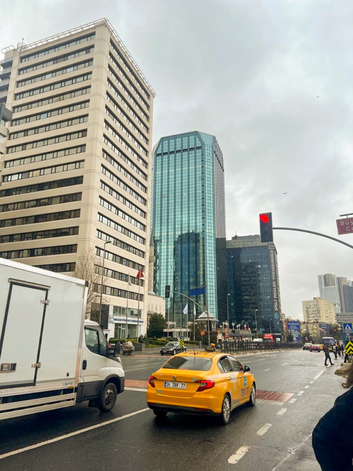 Yellow taxi among modern towers in Istanbul